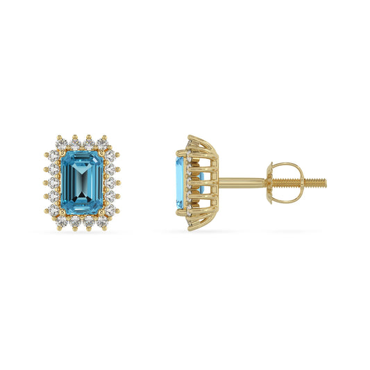 natural swiss blue topaz emerald cut stud earrings in yellow gold