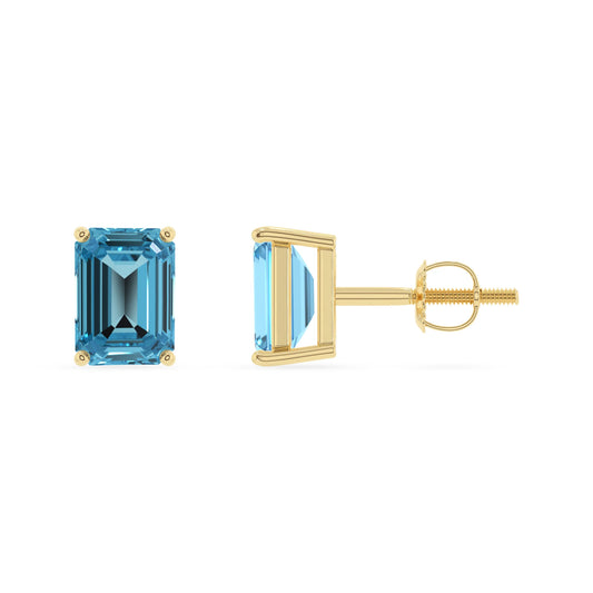 natural swiss blue topaz emerald cut stud earrings in yellow gold