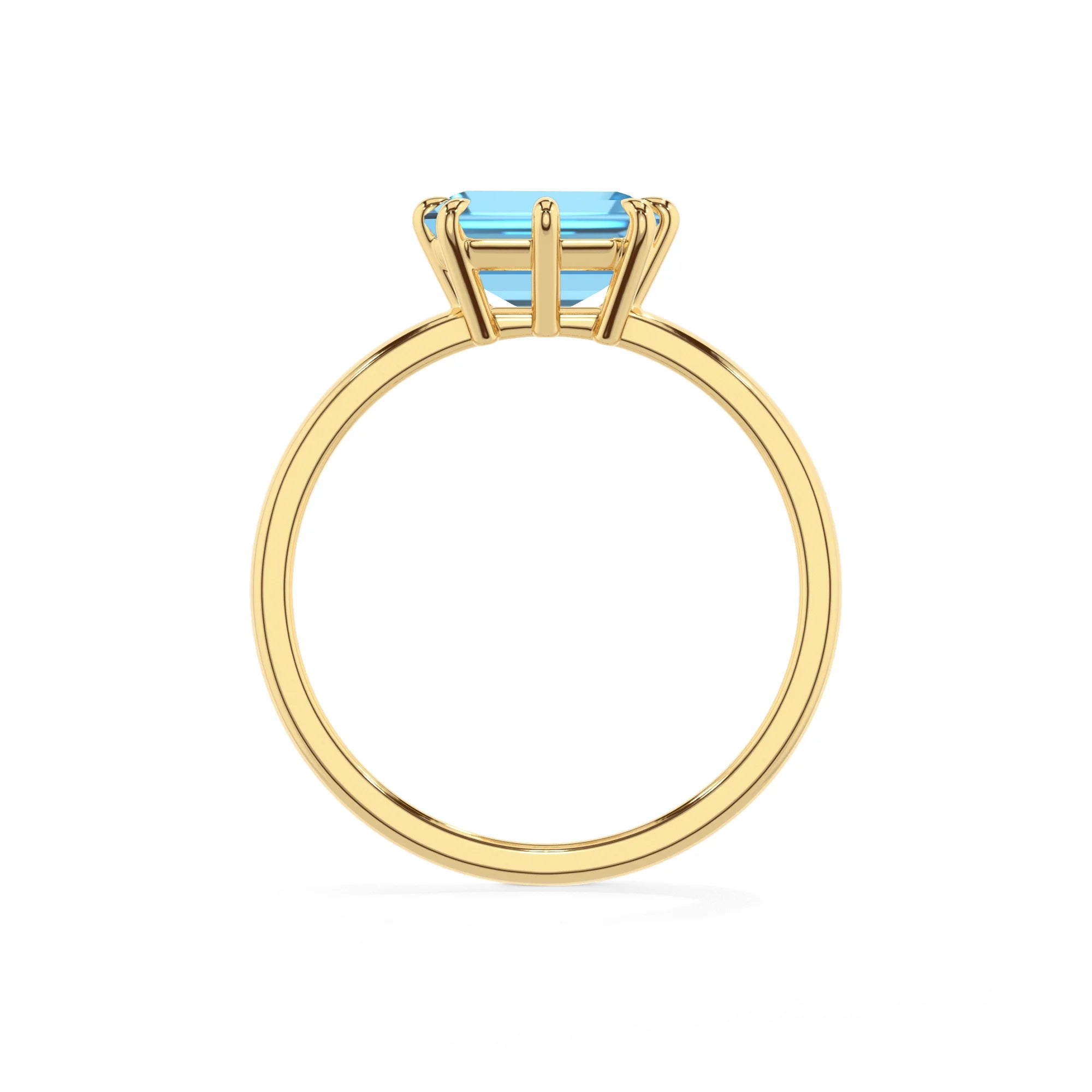 natural swiss-blue-topaz emerald cut solitaire rings in yellow gold