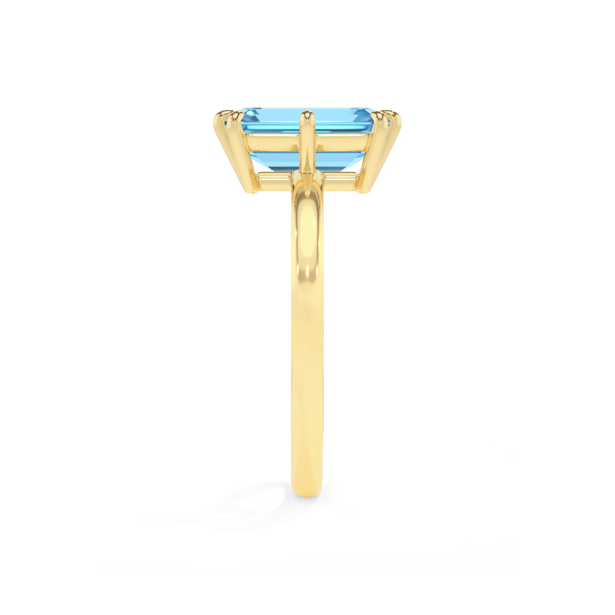 natural swiss-blue-topaz emerald cut solitaire rings in yellow gold