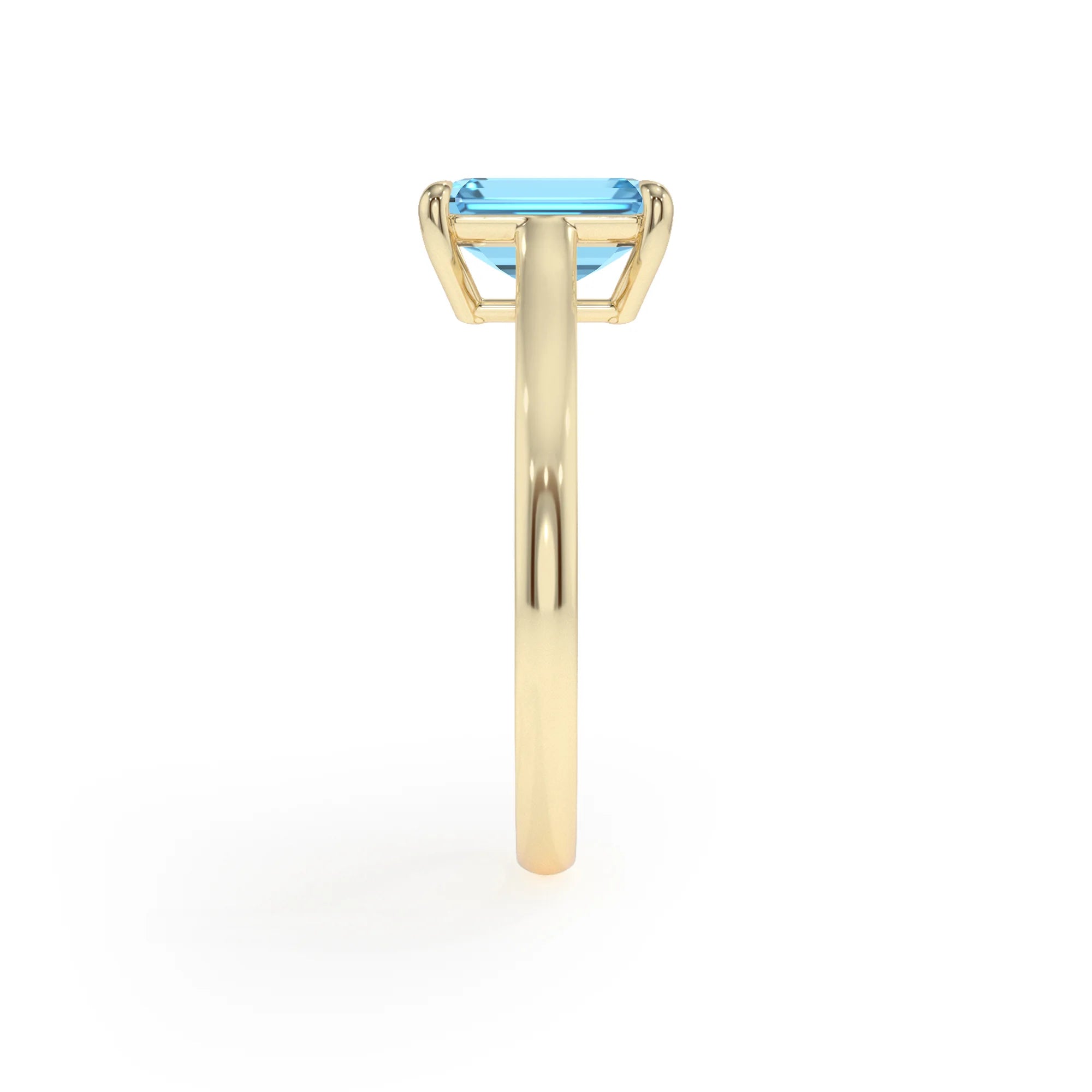 natural swiss-blue-topaz emerald cut solitaire rings in yellow gold