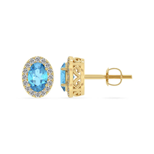 natural swiss blue topaz oval stud earrings in yellow gold 