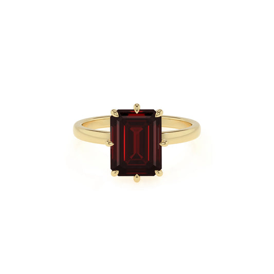 natural garnet emerald cut solitaire rings in yellow gold 