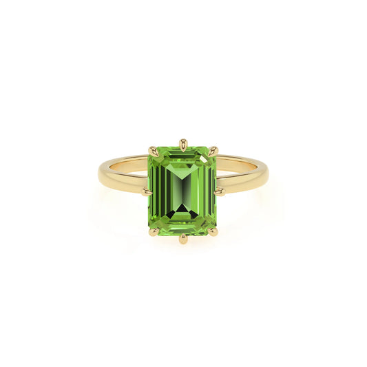 natural peridot emerald cut solitaire rings in yellow gold 