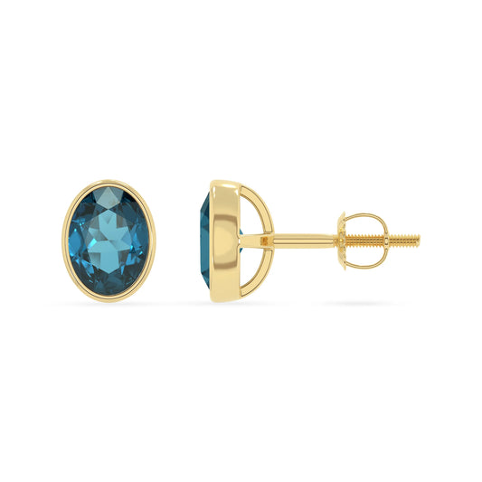 natural london blue topaz oval stud earrings in yellow gold 