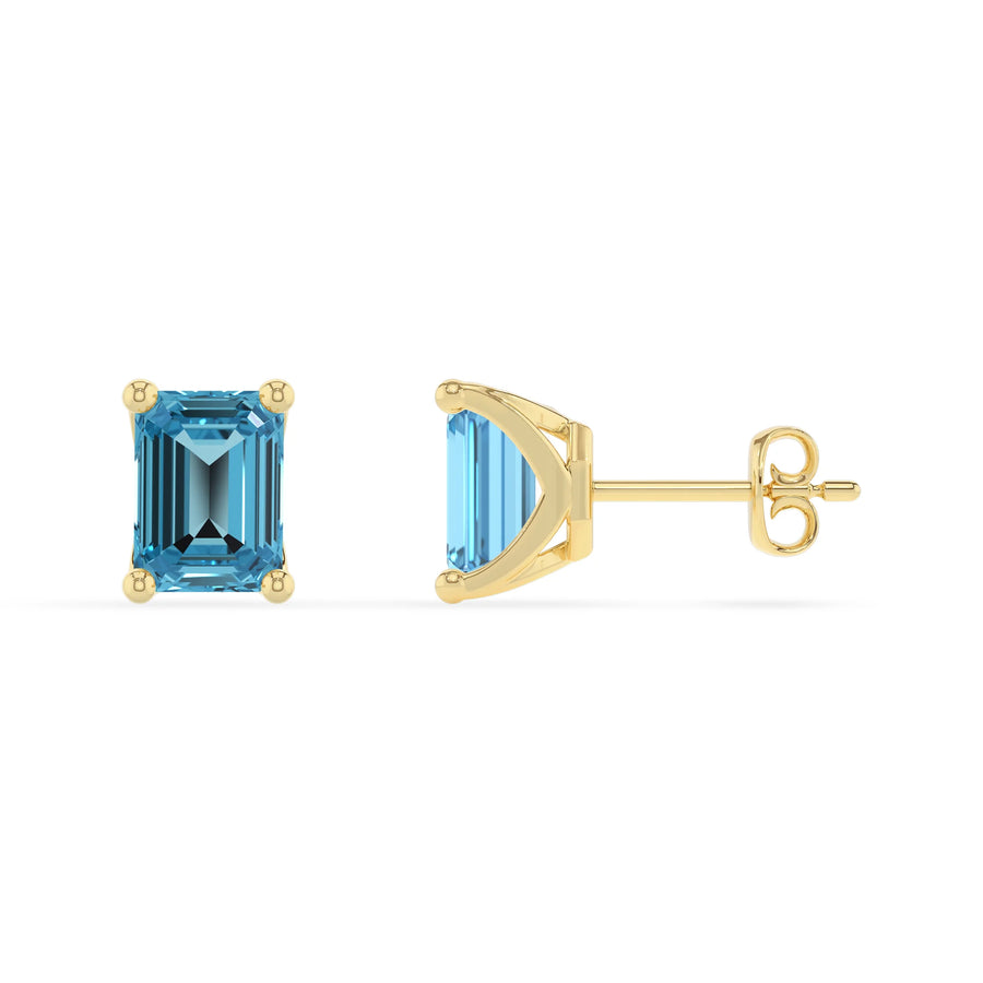 natural swiss blue topaz emerald cut stud earrings in yellow gold 