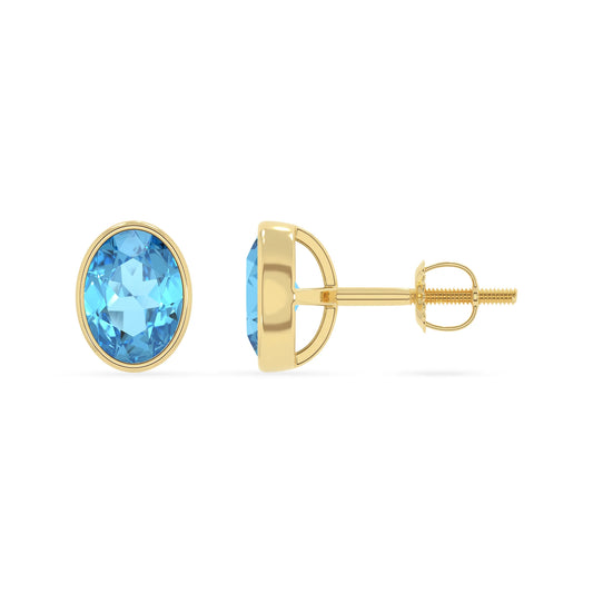 natural swiss blue topaz oval stud earrings in yellow gold 
