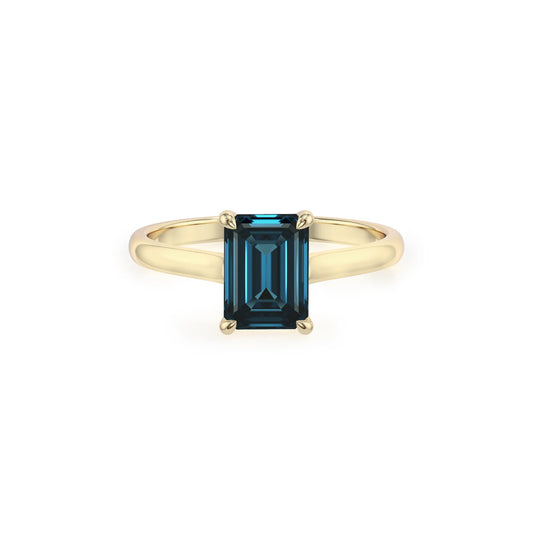 natural london-blue-topaz emerald cut solitaire rings in yellow gold 