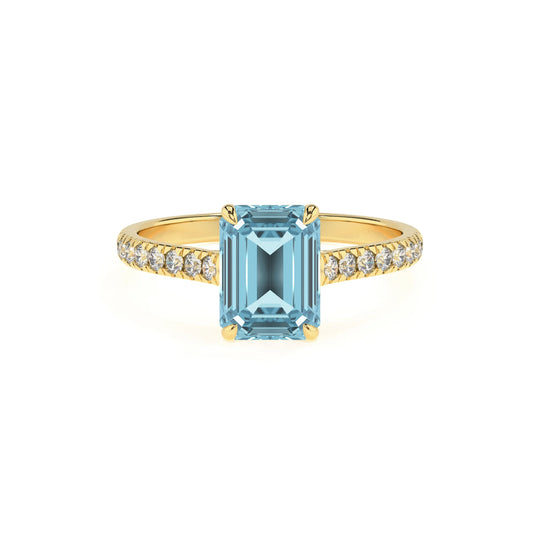 lab grown aquamarine emerald cut half eternity solitaire engagement rings in yellow gold 