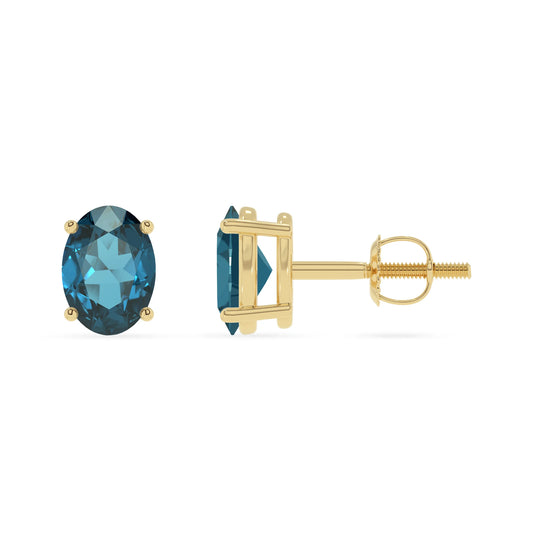 natural london blue topaz oval stud earrings in yellow gold 