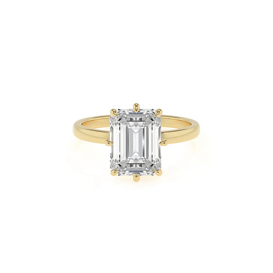 lab grown moissanite emerald cut solitaire rings in yellow gold 
