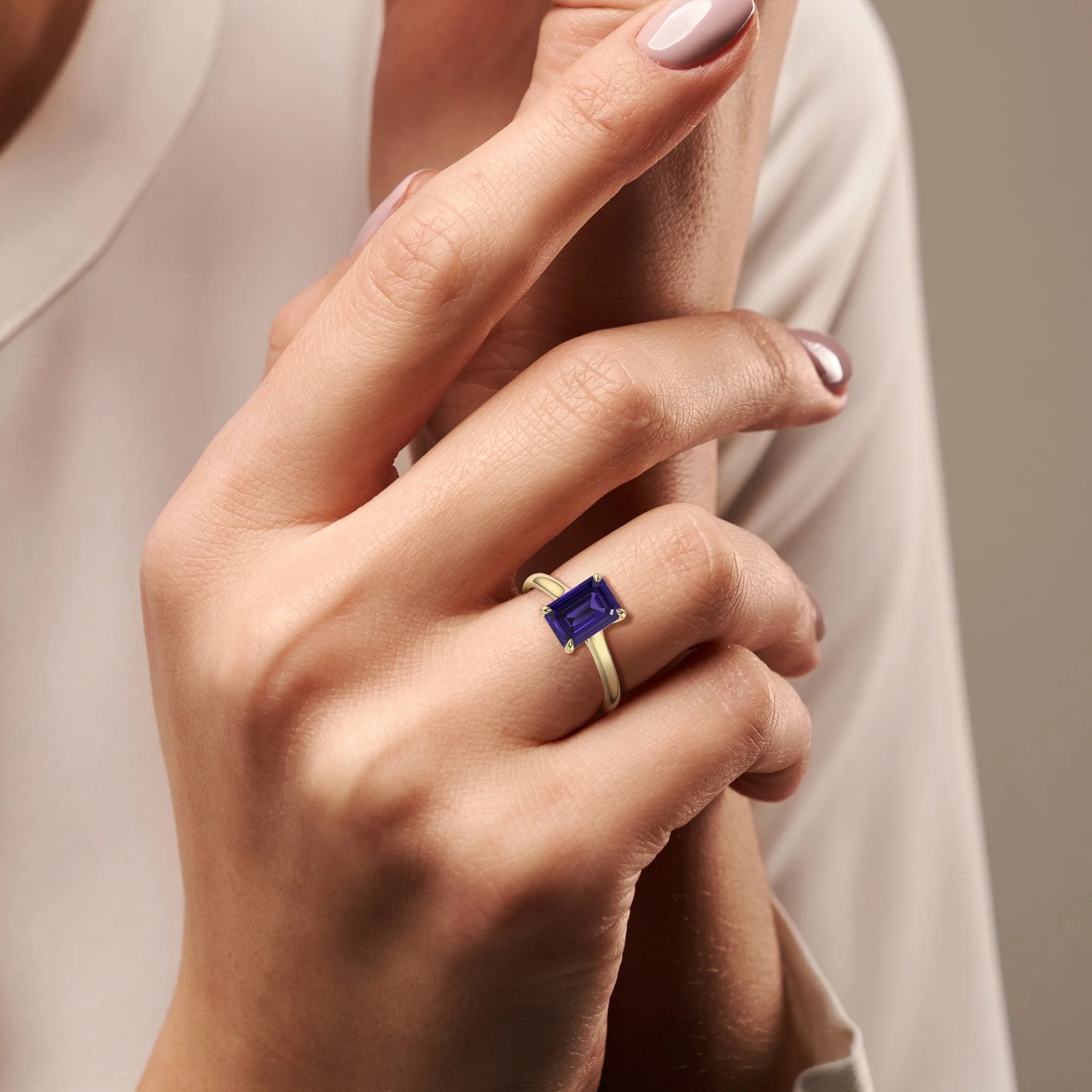 lab grown tanzanite emerald cut solitaire rings in yellow gold 
